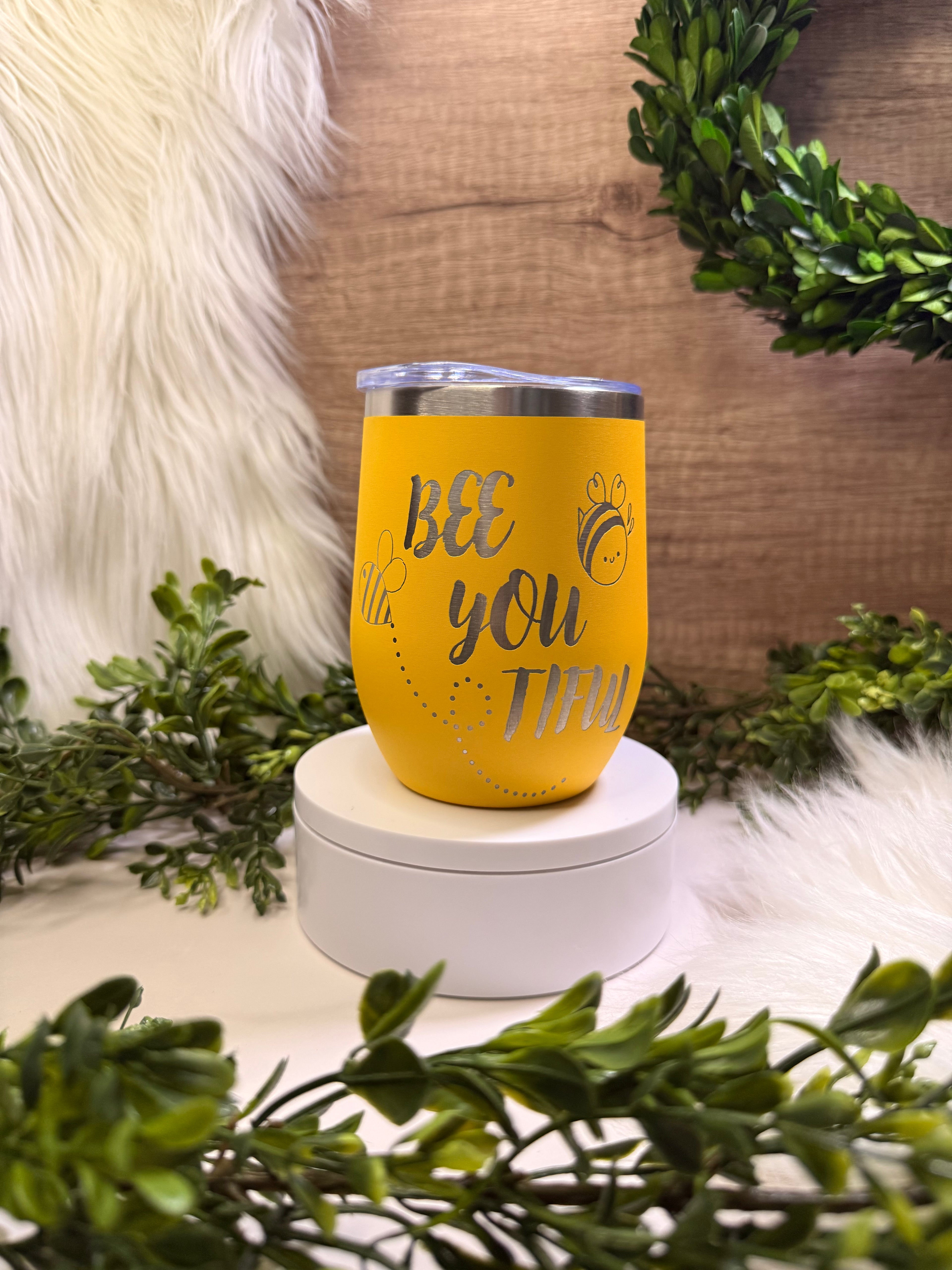 Yellow tumbler with 'BEE YOU TIFUL' text surrounded by bees