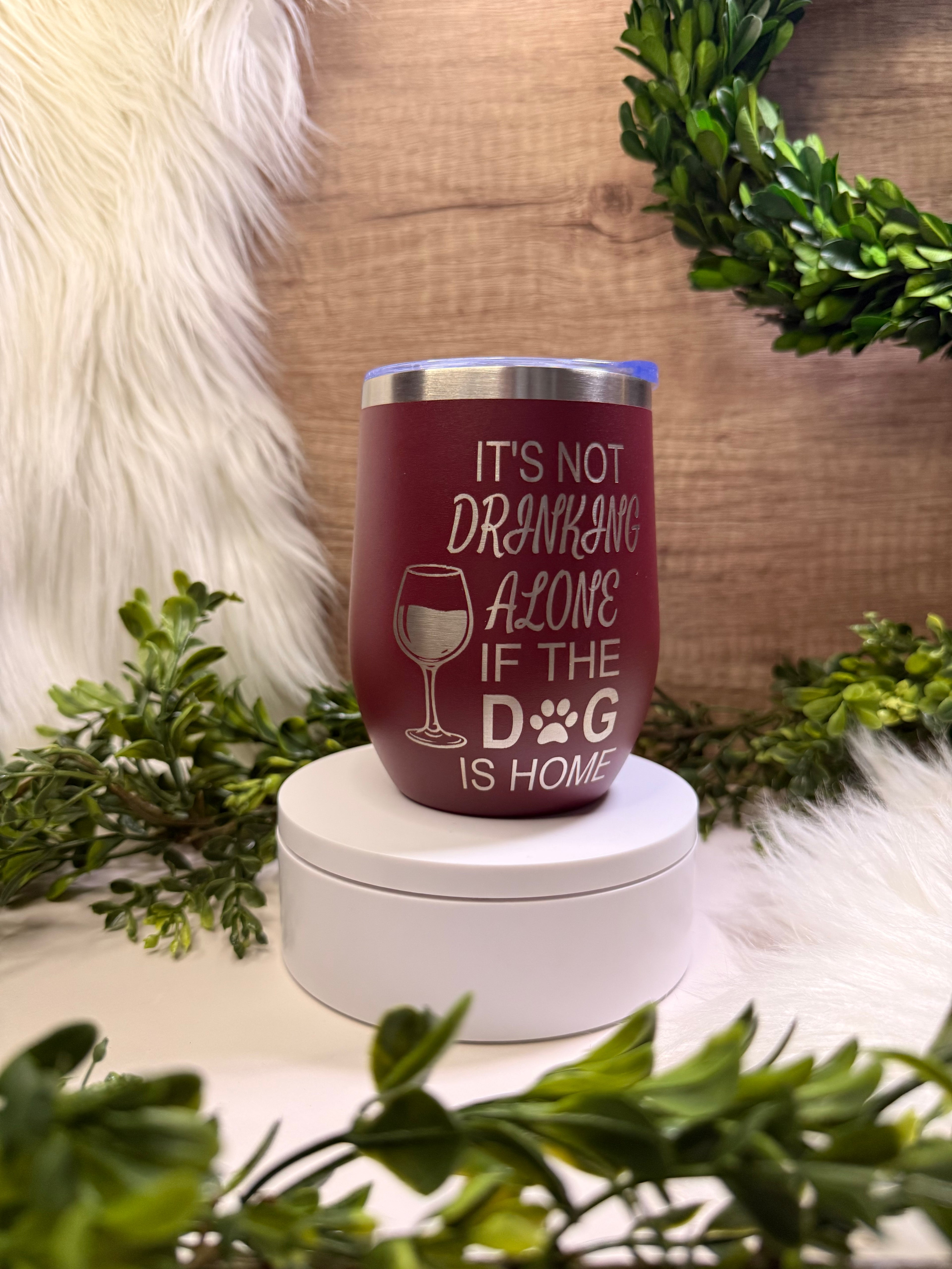 Maroon tumbler with text and wine glass icon not drinking alone dog is home