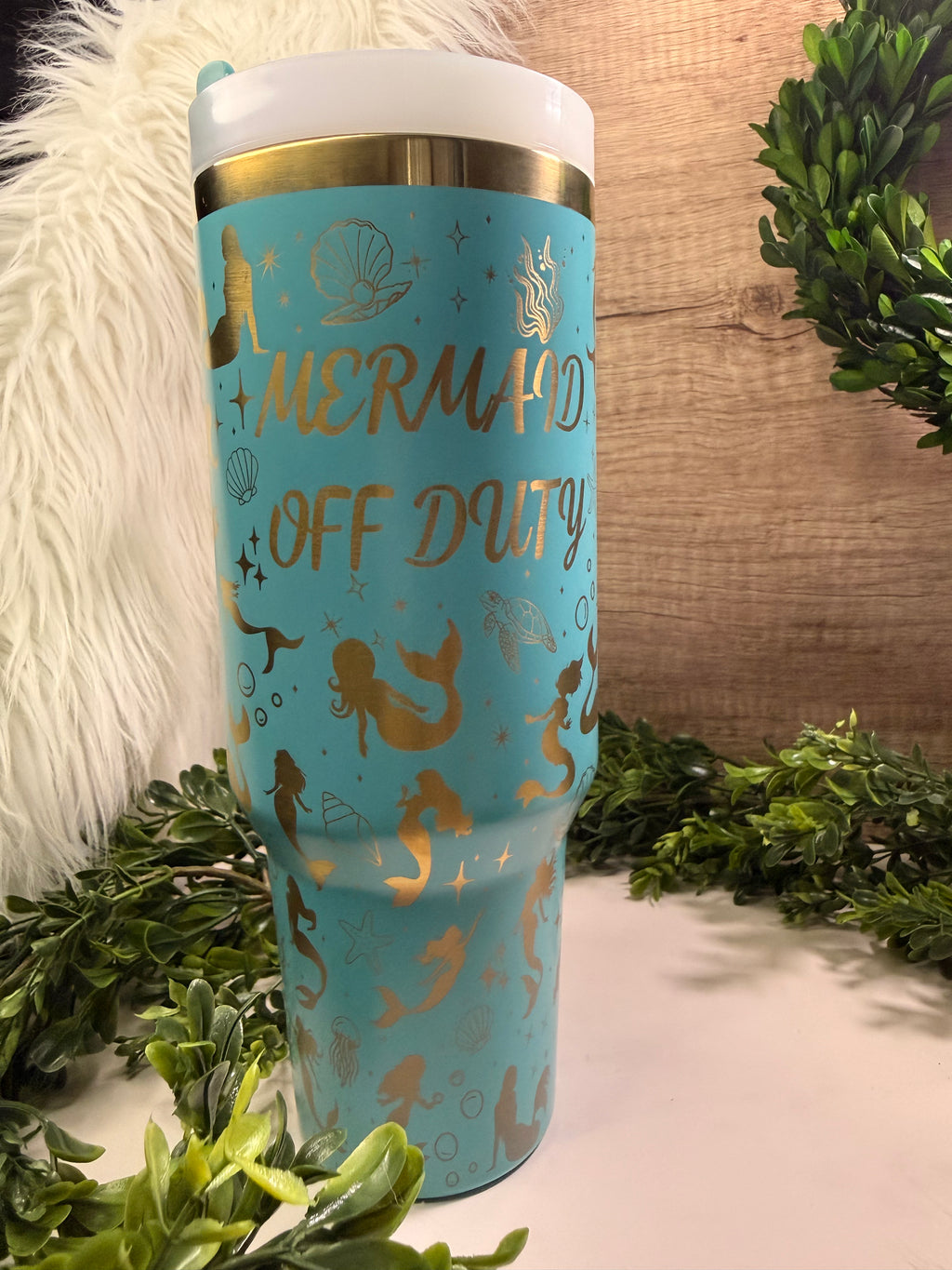Blue tumbler with gold mermaid design and 'Mermaid Off Duty' text, surrounded by mermaids, seashells, sea animals