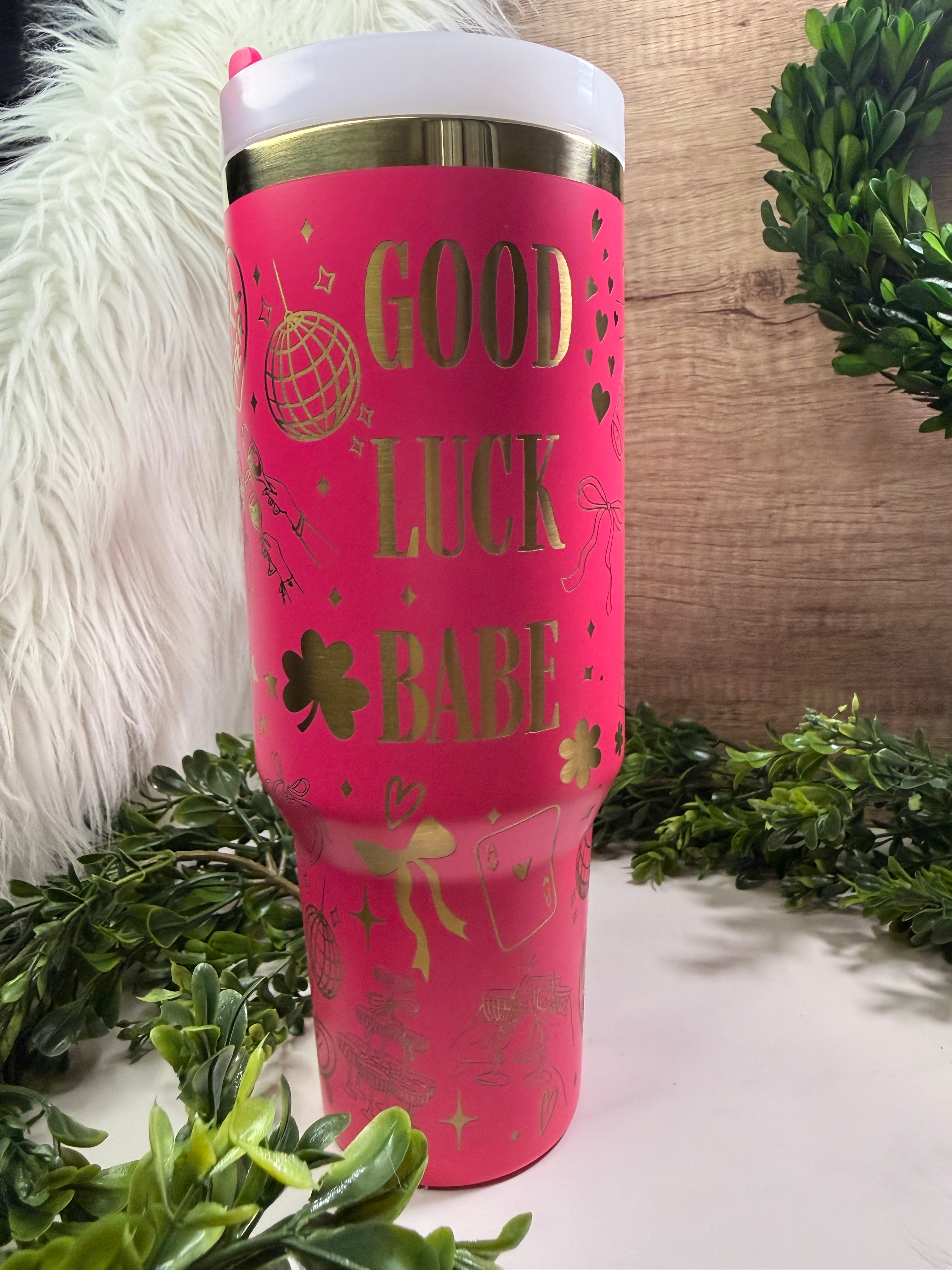 Pink tumbler with 'Good Luck Babe' text and disco balls, bows, champagne