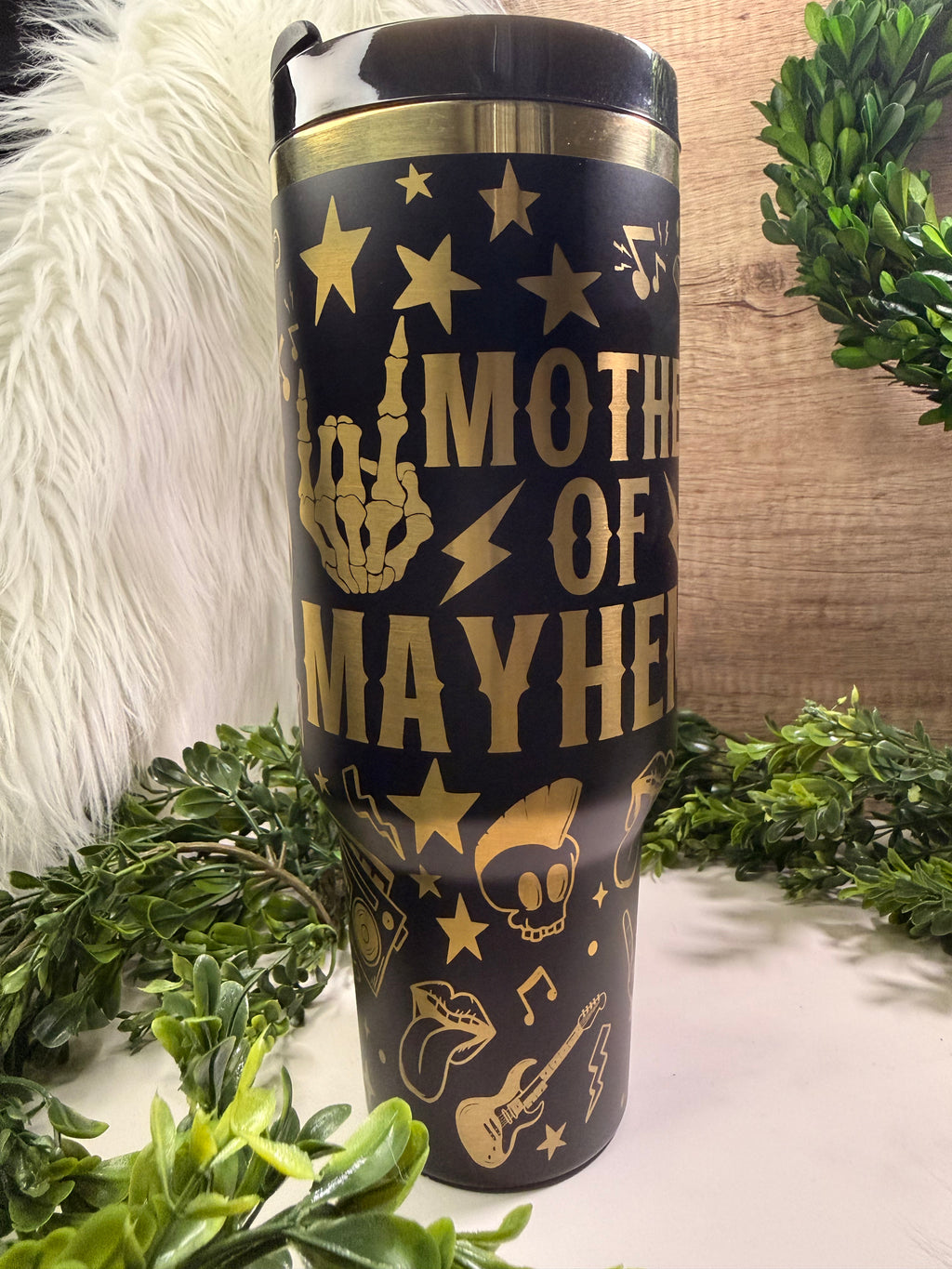 Black tumbler with gold rocker designs and text saying mother of mayhem