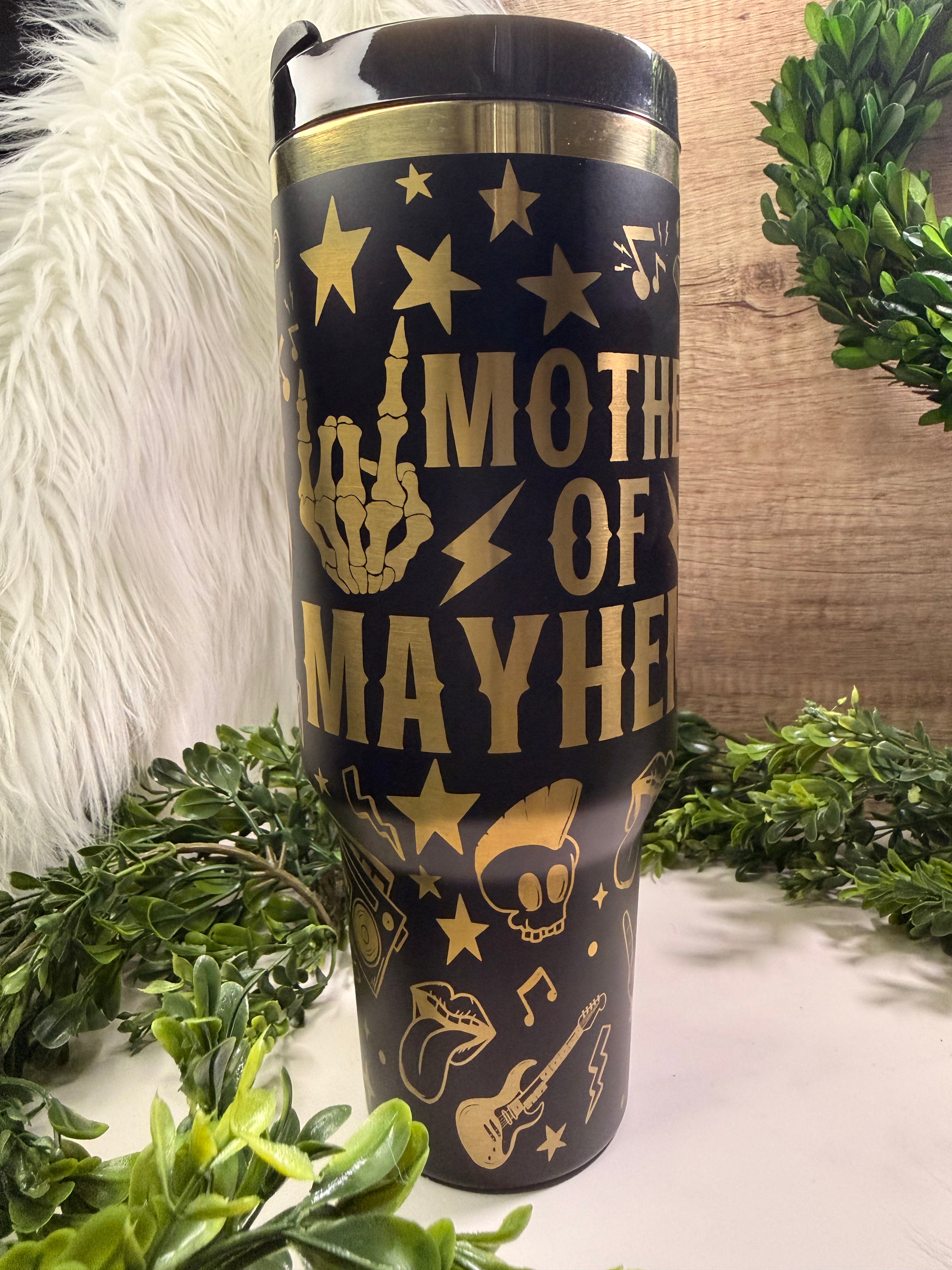 Black tumbler with gold rocker designs and text saying mother of mayhem