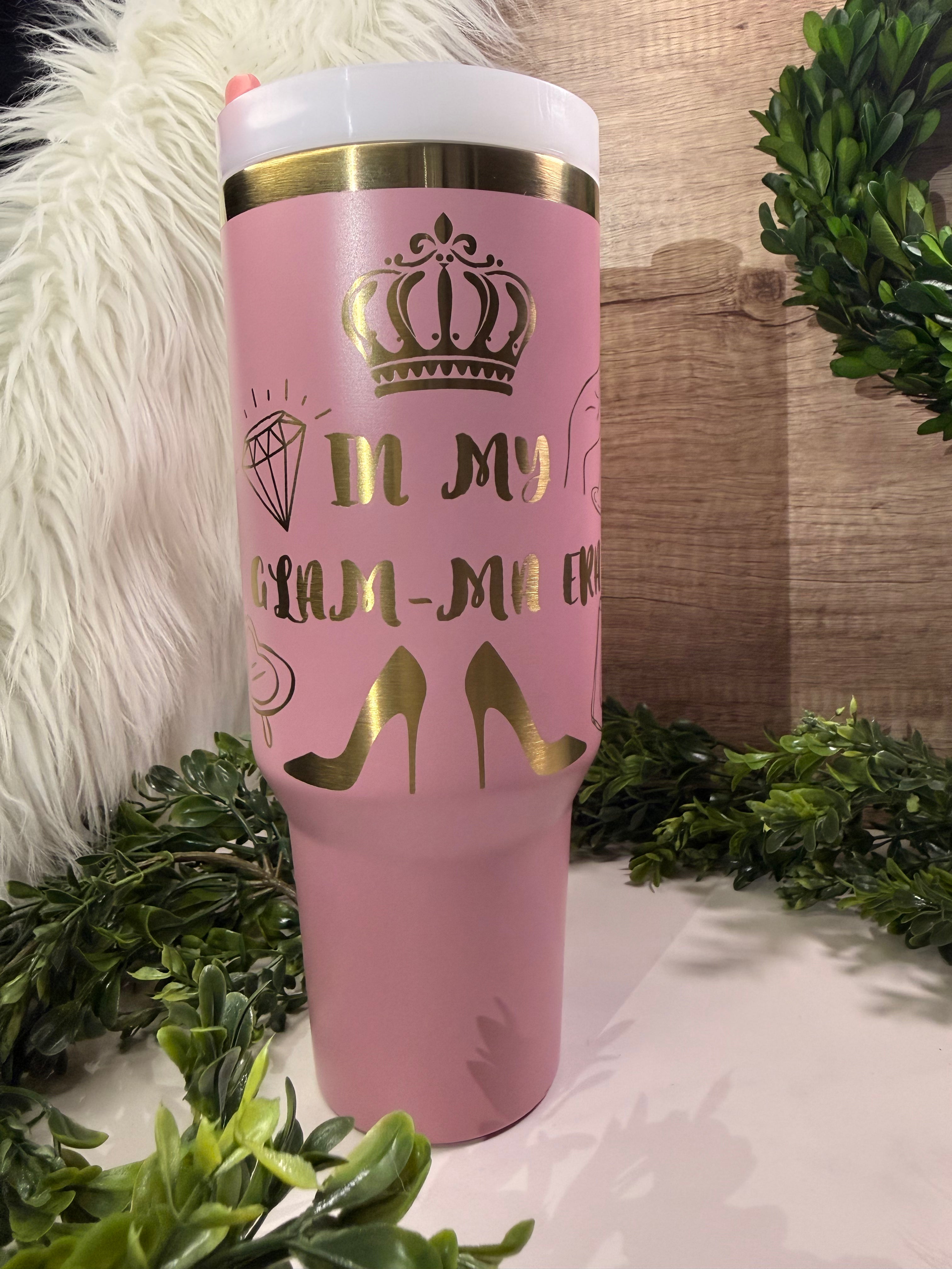 Pink tumbler with gold text "IN My Glam-ma era" and luxury designs 