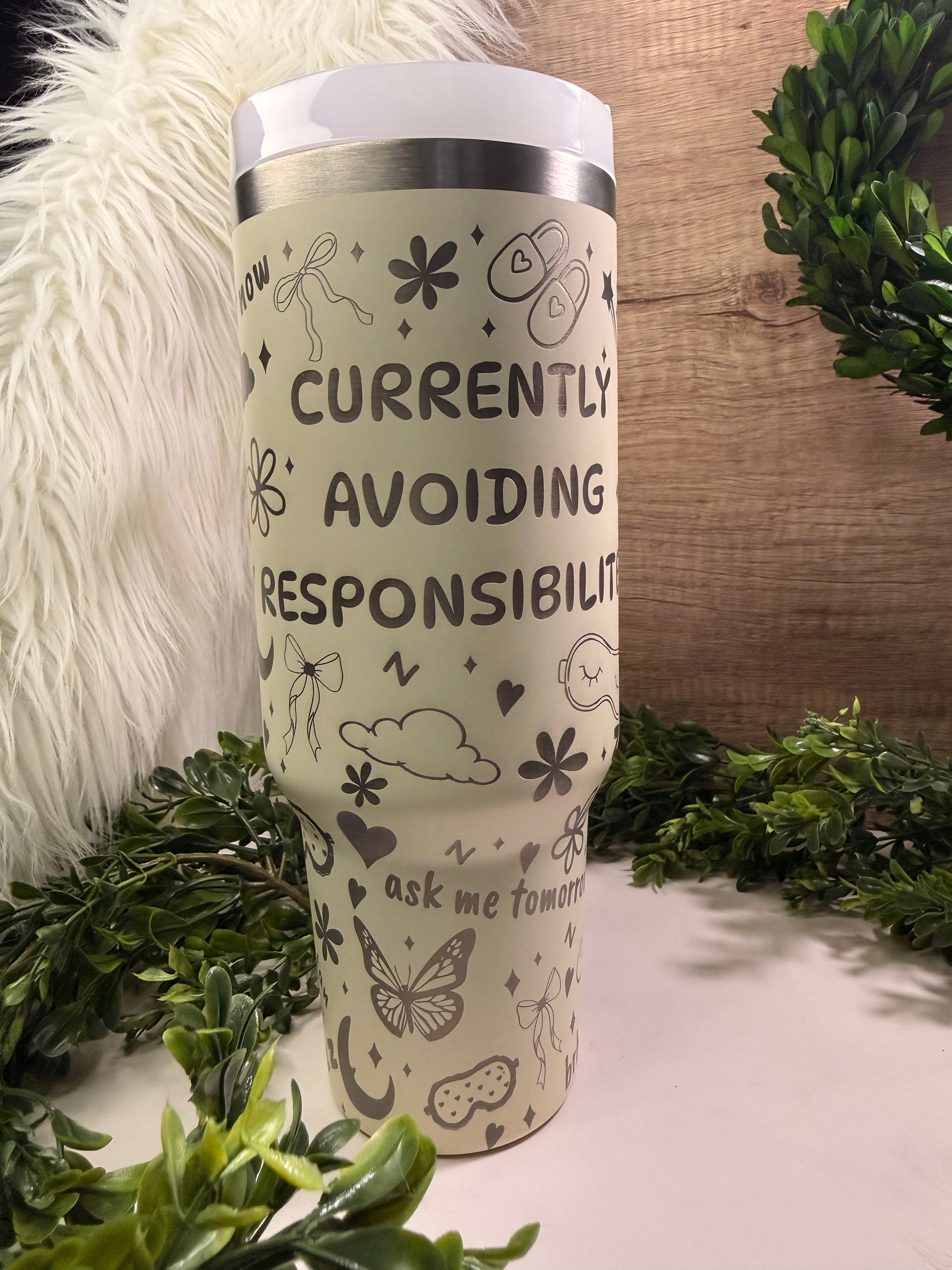 Tumbler with text 'Currently Avoiding Responsibility' surrounded by bows, butterflies, clouds, slippers, and starts