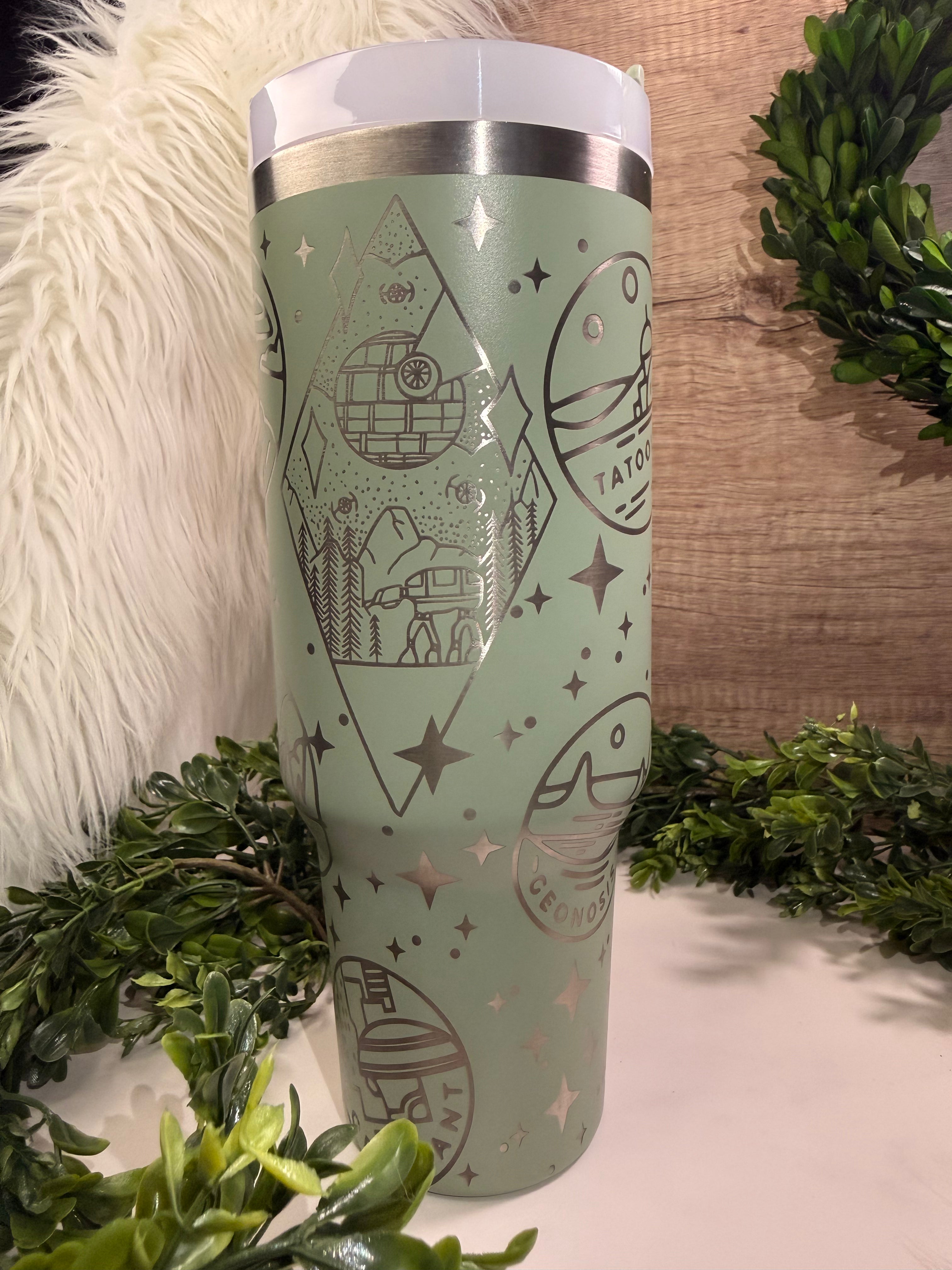 Green tumbler with Star Wars themed designs with planet stickers and stars