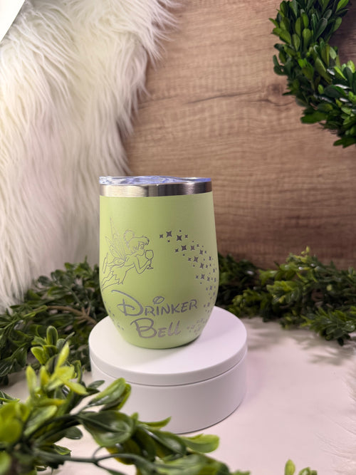 Green tumbler with 'Drinker Bell' text and tinker bell with pixie dust