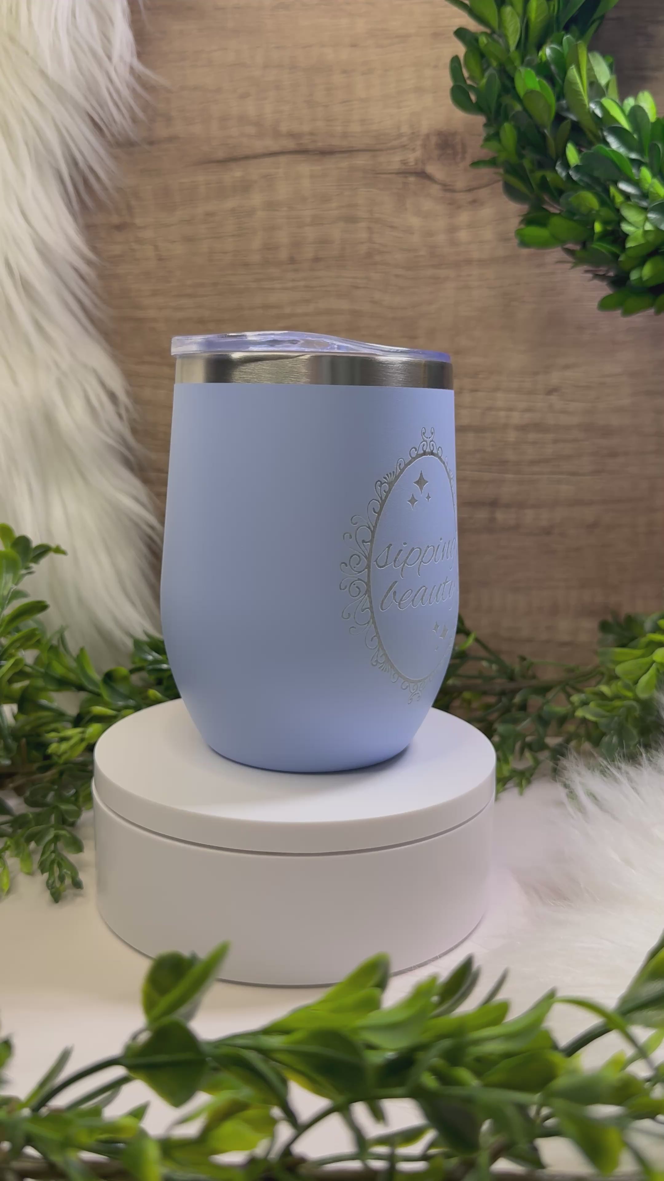 Light blue wine tumbler engraved with “Sipping Beauty” in elegant decorative frame