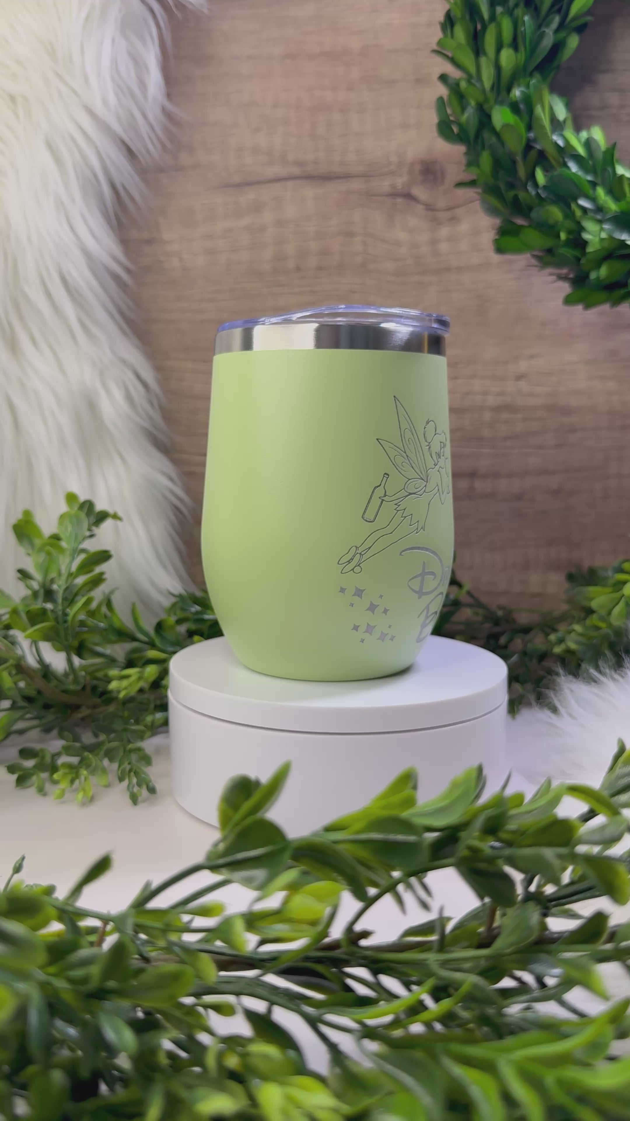 Light green wine tumbler engraved with fairy holding wine glass and “Drinker Bell” text